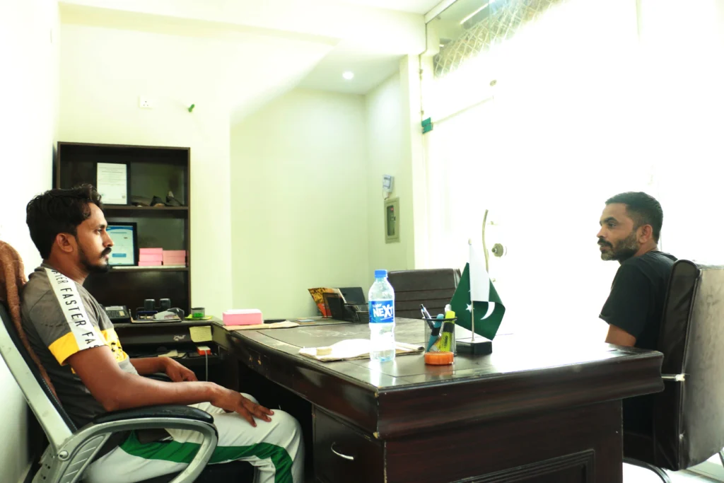 Roof Power Enterprises Pvt Ltd team discussing client waterproofing requirements at Lahore office